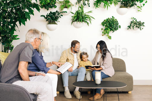 Young Family Reading the Bible with an Older Couple