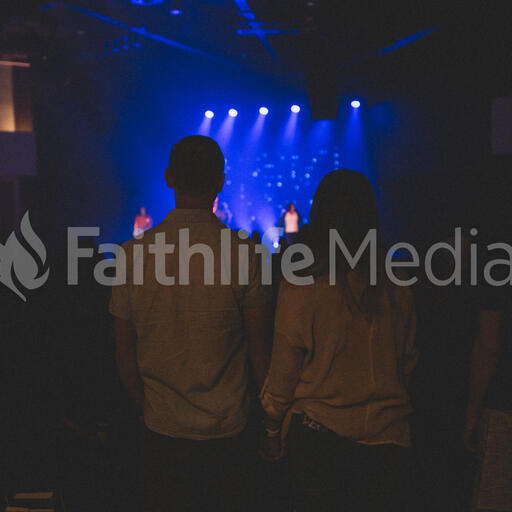 Couple Holding Hands During Worship Service