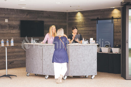 Woman Talking to Volunteers at Info Desk