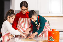 Mother and Children Baking Christmas Cookies Together  image 4