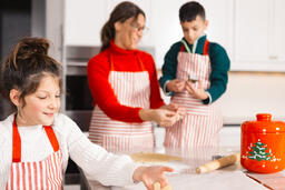 Mother and Children Baking Christmas Cookies Together  image 2