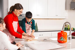 Mother and Children Baking Christmas Cookies Together  image 3