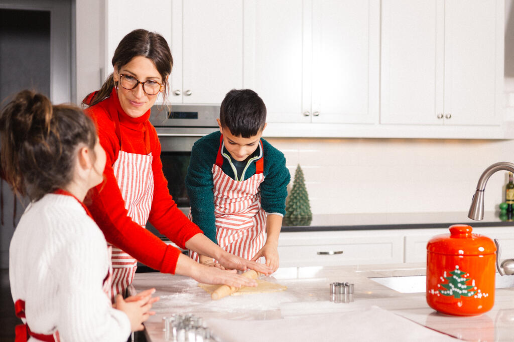 Mother and Children Baking Christmas Cookies Together large preview