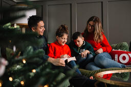 Young Family Reading the Bible Together at Christmastime  image 2