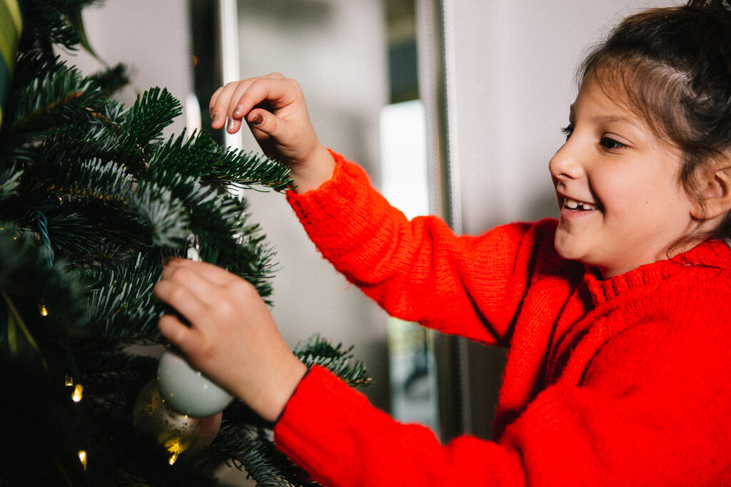 Young Girl Decorating the Christmas Tree large preview