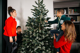 Mother and Children Decorating the Christmas Tree Together  image 2