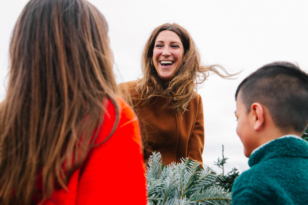 Mother Laughing with Her Children at a Christmas Tree Farm large preview