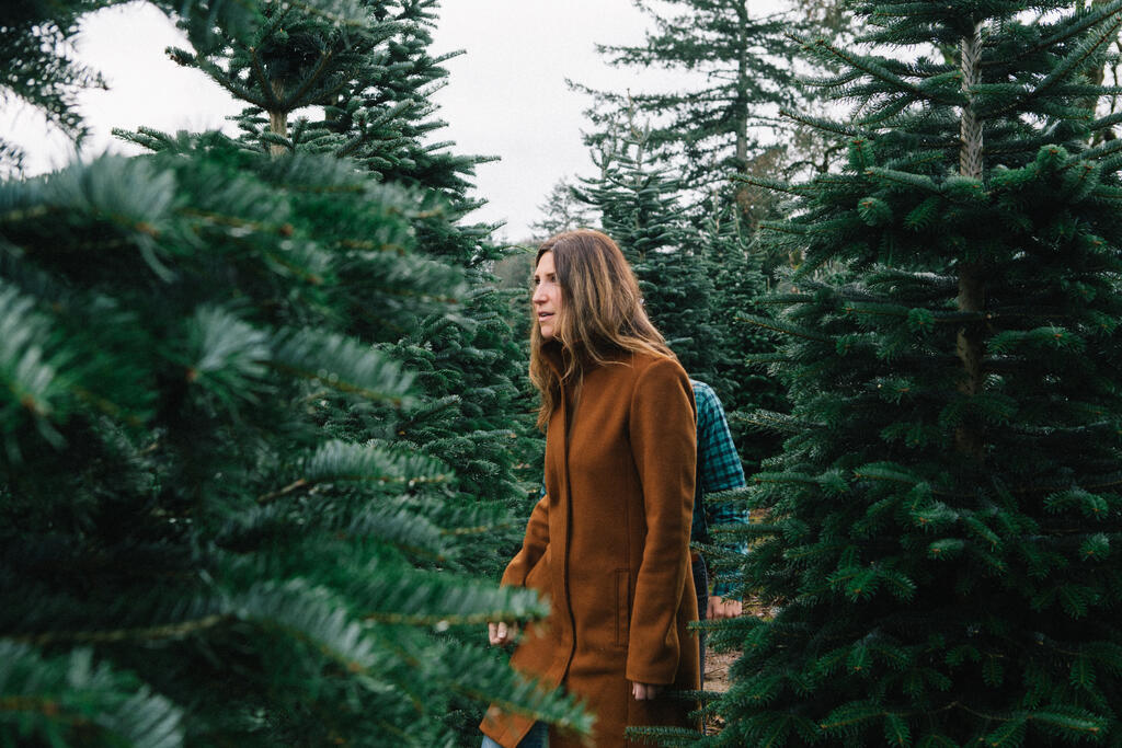 Woman Walking Through a Christmas Tree Farm large preview