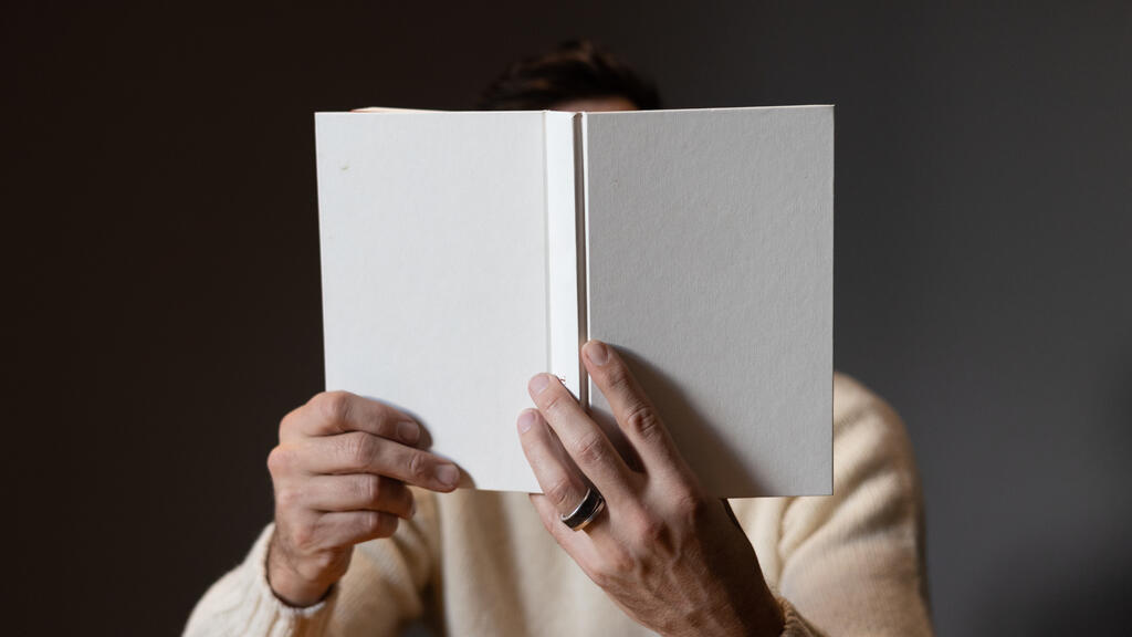 Man Reading a White Blank Book large preview