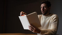 Man Reading a White Blank Book  image 2