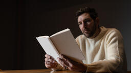 Man Reading a White Blank Book  image 1