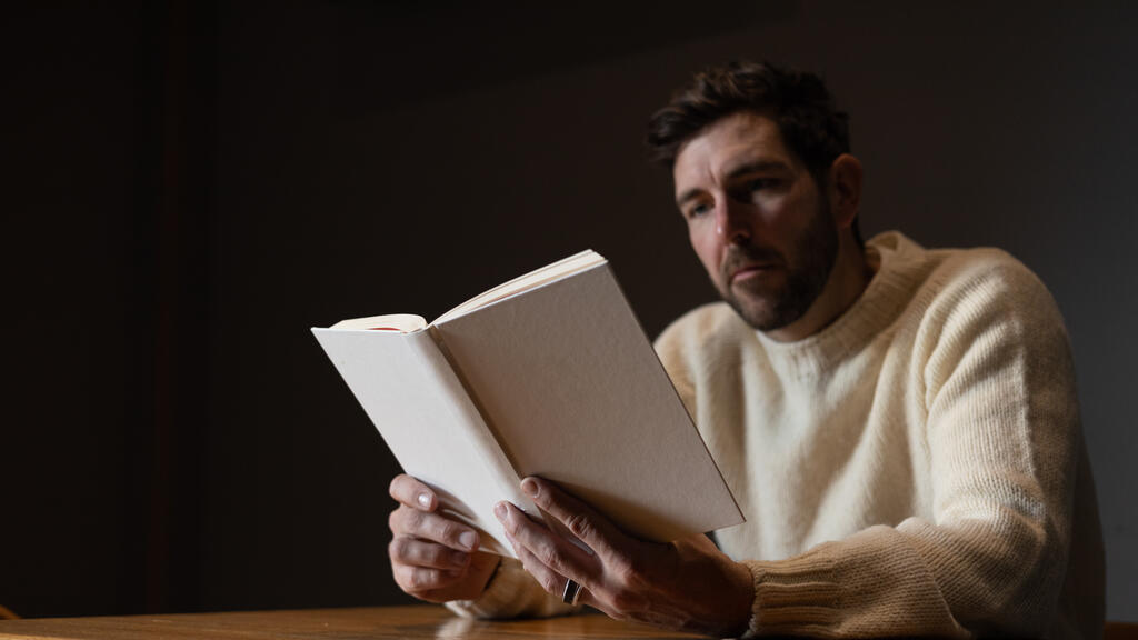 Man Reading a White Blank Book large preview
