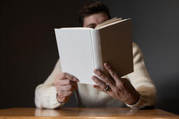 Man Reading a White Blank Book  image 4