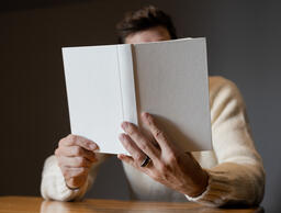Man Reading a White Blank Book  image 3