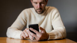 Man Scrolling on His Phone Alone  image 2