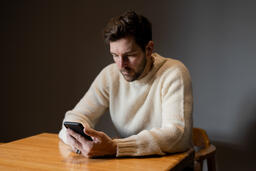 Man Scrolling on His Phone Alone  image 3