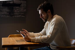 Man Reading on an iPad Alone  image 3