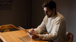 Man Reading on an iPad Alone  image 6