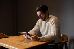 Man Reading on an iPad Alone  image 2