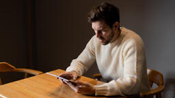 Man Reading on an iPad Alone  image 1
