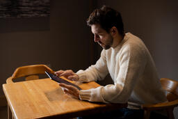 Man Reading on an iPad Alone  image 5