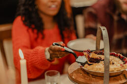 Woman Serving Up Pie at the Thanksgiving Table  image 2