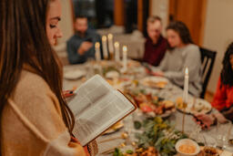Woman Reading from the Bible before Thanksgiving Dinner  image 2