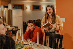 Woman Reading from the Bible before Thanksgiving Dinner  image 3