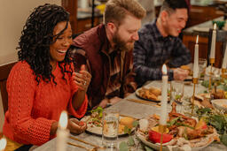 Friends Laughing and Enjoying Thanksgiving Dinner Together  image 5