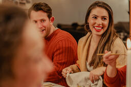 Friends Laughing and Enjoying Thanksgiving Dinner Together  image 2