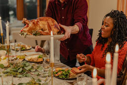 Man Placing the Thanksgiving Turkey on the Dinner Table  image 4