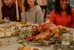 Man Placing the Thanksgiving Turkey on the Dinner Table  image 3