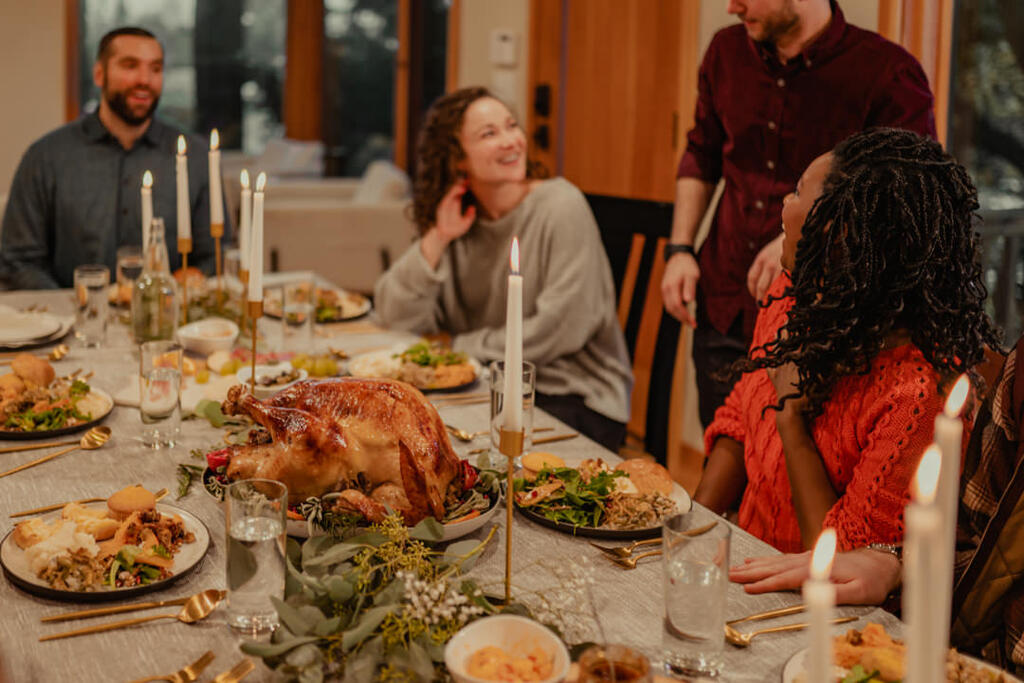 Friends Laughing and Enjoying Thanksgiving Dinner Together large preview
