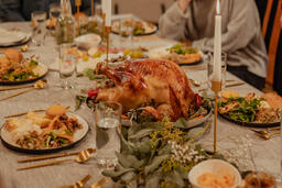 Man Placing the Thanksgiving Turkey on the Dinner Table  image 2