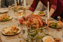 Man Placing the Thanksgiving Turkey on the Dinner Table  image 7