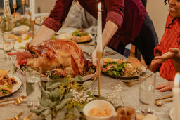 Man Placing the Thanksgiving Turkey on the Dinner Table  image 5