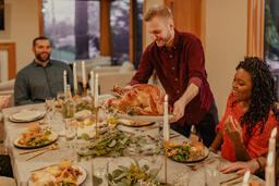 Man Placing the Thanksgiving Turkey on the Dinner Table  image 6