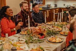 Friends Laughing and Enjoying Thanksgiving Dinner Together  image 6