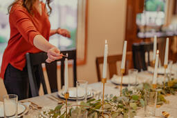 Woman Lighting Candles at the Thanksgiving Table  image 2