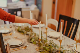 Woman Lighting Candles at the Thanksgiving Table  image 3