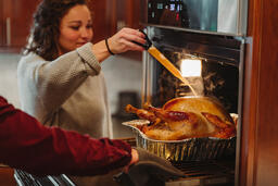 Friends Basting the Thanksgiving Turkey Together  image 4