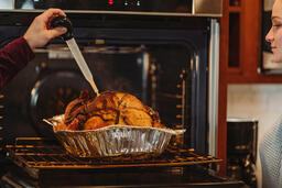 Friends Basting the Thanksgiving Turkey Together  image 3
