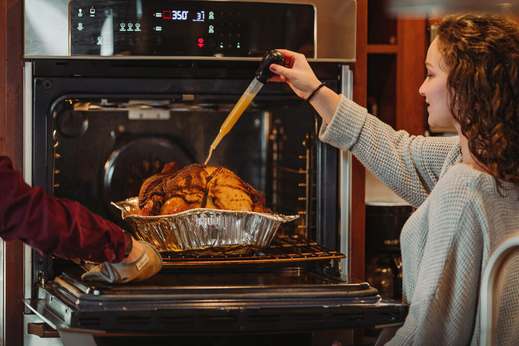 Friends Basting the Thanksgiving Turkey Together large preview