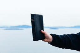 Man Holding a Bible Up in the Air  image 2