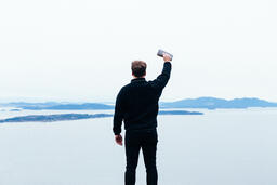 Man Holding a Bible Up in the Air  image 3