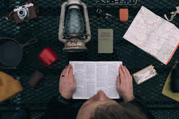 Man Reading the Bible while Camping  image 1