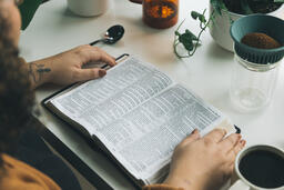 Woman Reading the Bible while Making Coffee  image 1