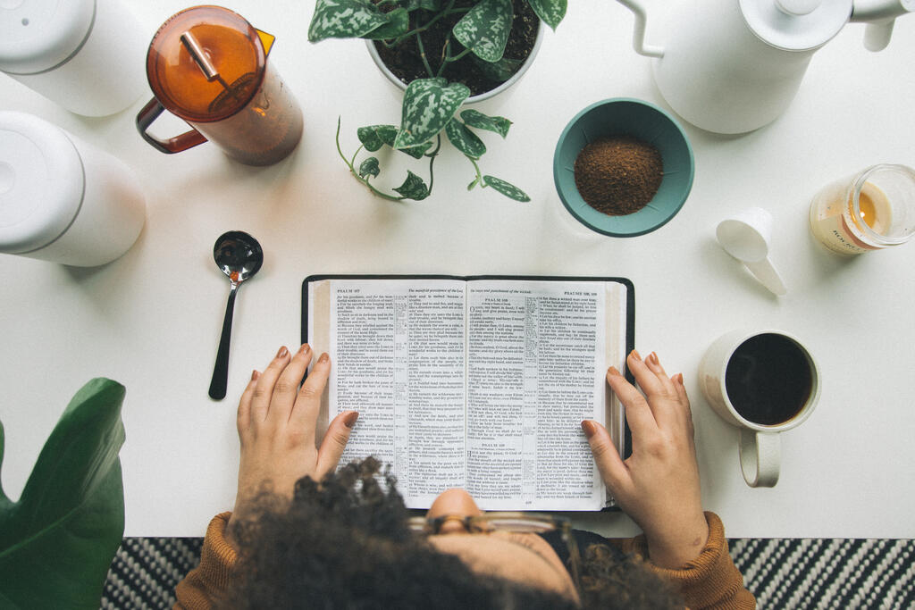 Woman Reading the Bible while Making Coffee large preview
