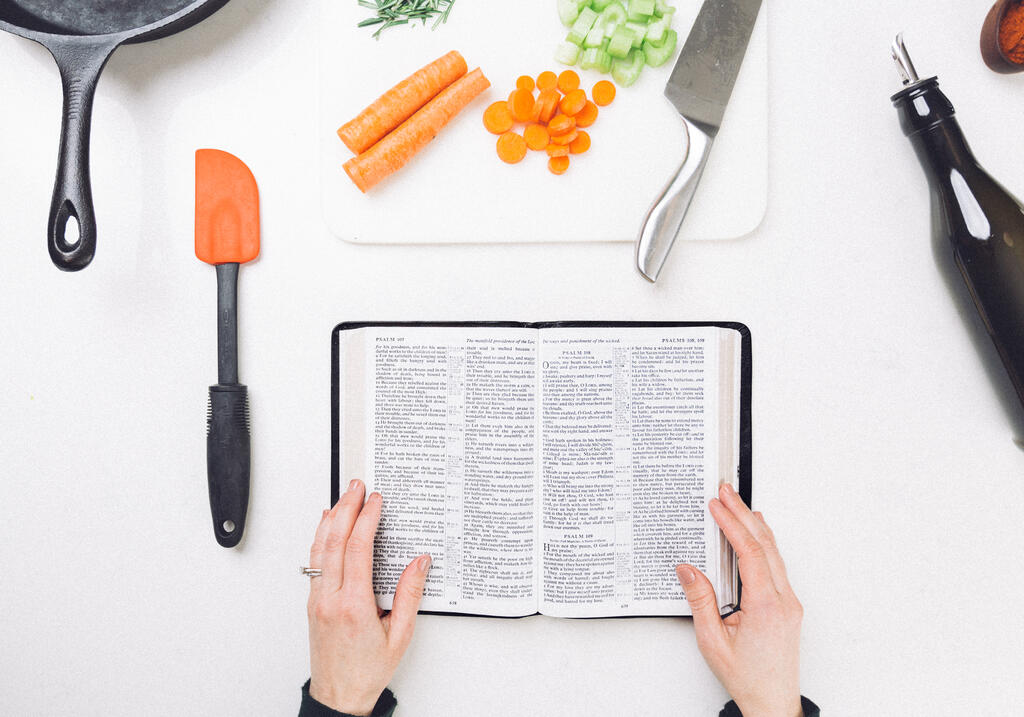 Woman Reading the Bible while Cooking large preview