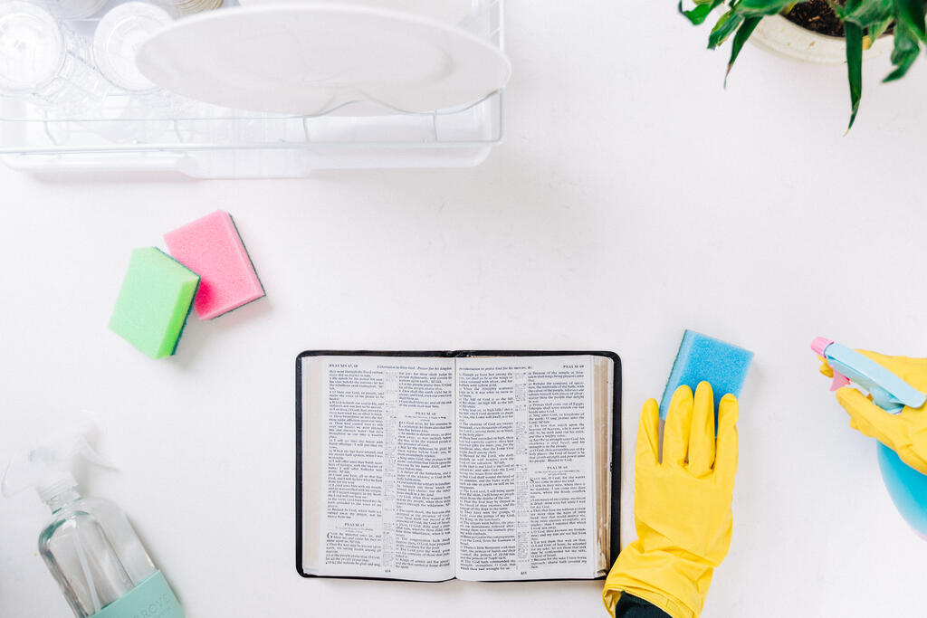 Person Reading the Bible while Cleaning large preview